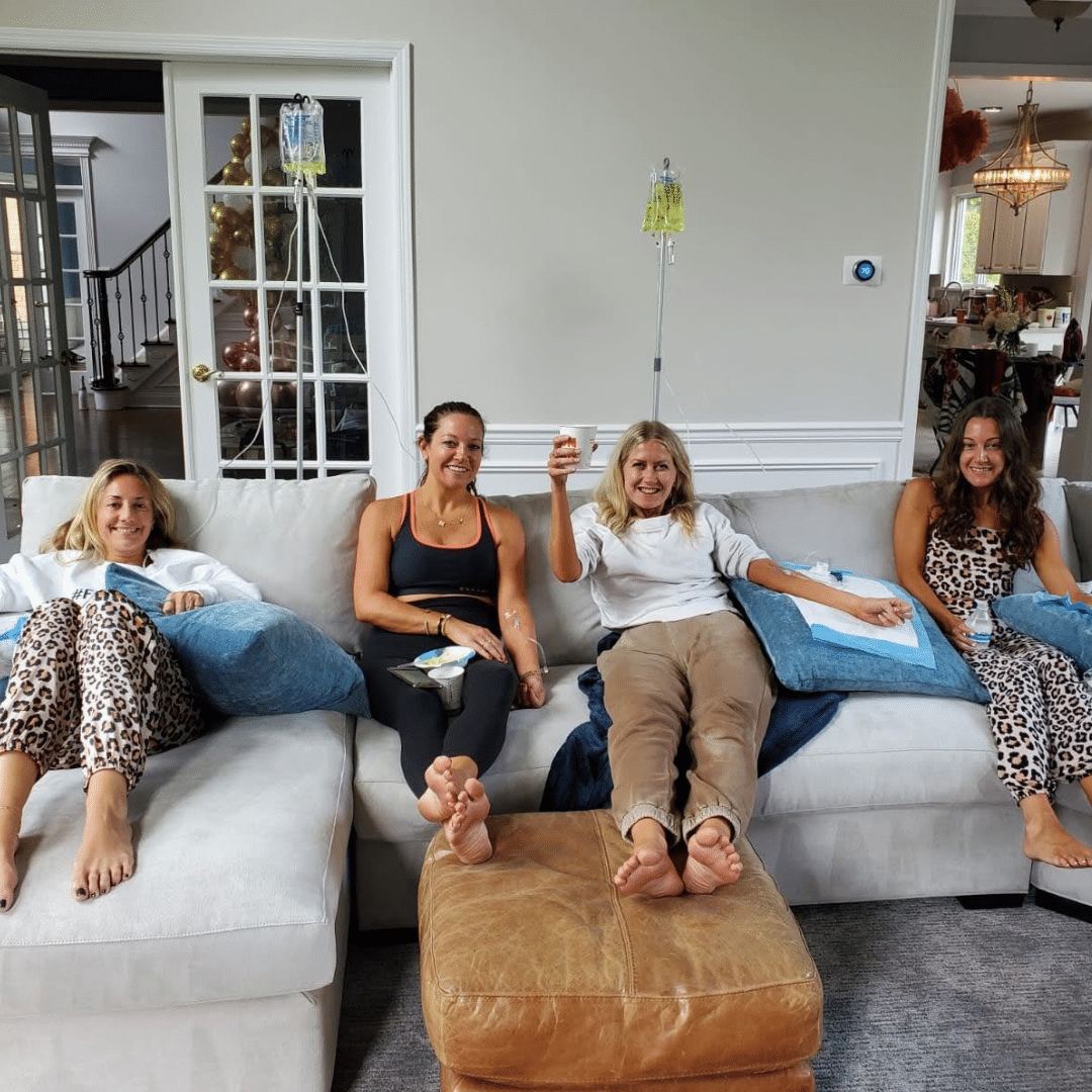 Group of friends receiving personalized IV drips together at their villa in Cabo